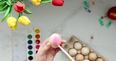 Enjoy a colorful Easter egg painting with vibrant tulips and delightful watercolors video