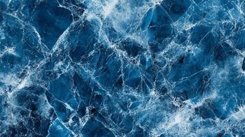 Striking blue marble texture with intricate white veining, creating a dramatic and luxurious feel. Ideal for backgrounds and designs. photo