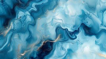 Swirling patterns of blue liquid, highlighted by gold accents, create a marbled effect, evoking a sense of calmness and movement. photo
