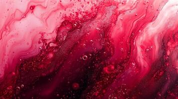 Abstract crimson and pink fluid art featuring swirling patterns and tiny bubbles creates a visually striking and textured composition. photo