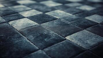 Monochrome checkered pavement design. A rhythmic arrangement of square paving stones in shades of gray creates a captivating visual texture. photo