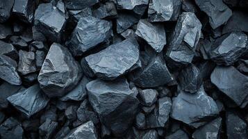 Close-up shot of a pile of rocks of varied sizes. The image captures the natural texture and depth of the rock formation. photo