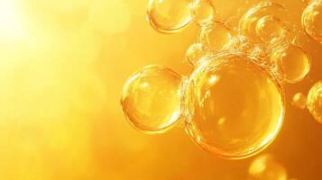 Yellow background with many bubbles of different sizes. The bubbles are floating in the air and appear to be made of a clear liquid. Concept of playfulness and lightheartedness photo