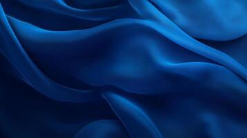 Abstract blue fabric waves, smooth and flowing, creating a sense of depth and motion with light and shadow interplay. Ideal backdrop. photo