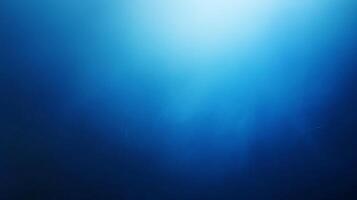 A mesmerizing image of a gradient of blue, moving from light to dark. The smooth transition creates a sense of depth and serenity. photo
