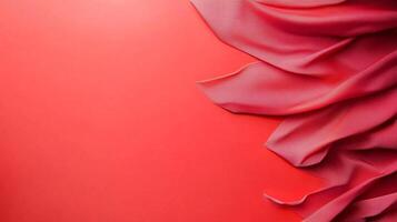 A striking image of draped, soft fabric contrasting against a vibrant red background. The smooth cloth creates an elegant, flowing pattern. photo