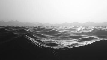 Monochromatic ocean waves roll toward the horizon beneath a hazy sky, distant land. The sea is textured and dramatic, creating depth. photo