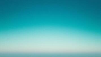 A gradient of calming blues fades from a saturated turquoise at the top to a soft, muted teal at the bottom, suggesting vastness. photo