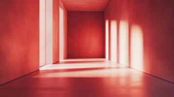 A vibrant red corridor with bright light streaming through vertical openings, creating strong shadows and highlighting textures. photo
