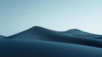 Serene blue sand dunes stretch toward a pale sky, creating a minimalistic and peaceful landscape. The smooth contours evoke a sense of calm. photo