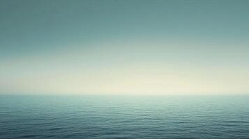 Calm, blue ocean stretches to the horizon under a soft, gradient sky, creating a peaceful and serene seascape scene photo