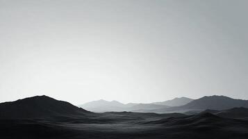 Monochromatic landscape featuring layered mountain ranges, with a hazy sky creating a serene and contemplative atmosphere. photo