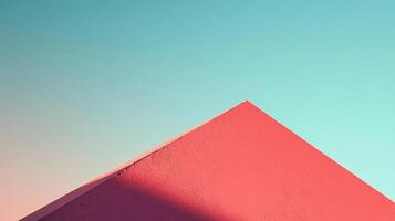 Minimalist architecture photo with a red wall corner against a gradient blue sky. Simple, clean, and visually appealing geometry.