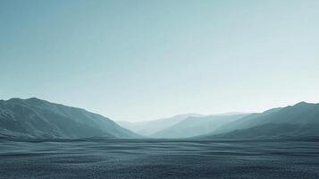 Vast, desolate landscape featuring distant mountains fading into a soft, clear sky above a flat, textured surface. Calm and minimalist. photo