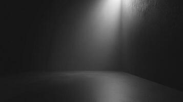 A stark spotlight illuminates a corner, casting light on the textured wall and smooth floor in a scene defined by monochrome contrast. photo