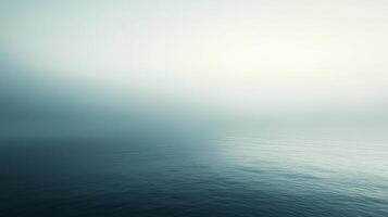 Expansive ocean view with gentle ripples on the water surface, transitioning to a soft, bright horizon under a serene sky. photo