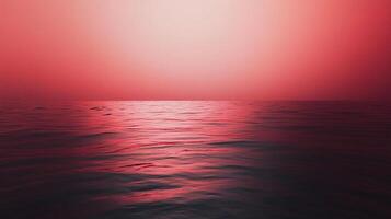 A serene seascape bathed in vibrant shades of red, featuring gentle ripples across the water's surface under a soft, diffuse sky. photo
