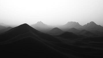 Monochromatic landscape featuring rolling hills and distant mountains shrouded in mist, creating a serene and dramatic atmosphere. photo