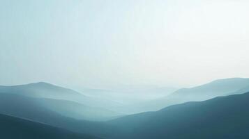 A serene mountain landscape rendered in soft blues and grays, showing depth through the misty atmosphere, layers of mountain peaks fade. photo