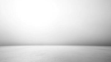 Minimalist backdrop featuring a soft gradient from light to dark gray, creating a versatile studio or presentation space with seamless horizon. photo