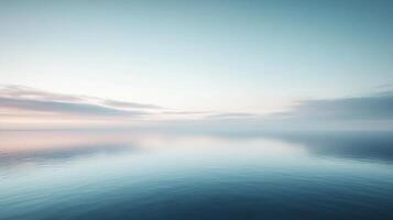 Calm ocean view under the light blue sky, with soft light reflecting on the smooth water surface, creating a peaceful atmosphere. photo