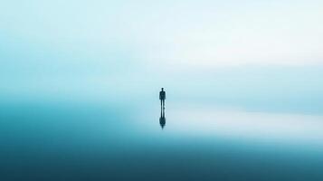 Isolated figure stands on reflective surface in vast blue, evoking solitude and contemplation. Mysterious aura, minimal composition. photo