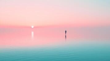 Lone figure stands silhouetted against the pastel dawn sky over calm waters, creating a serene and meditative scene. photo