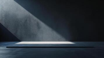 Minimalist scene featuring a ray of light illuminating a concrete floor against a dark wall, creating a stark contrast in a simple setting. photo