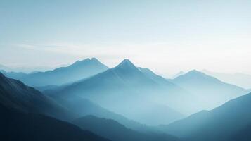 Panoramic view of majestic mountains layered in shades of blue, fading into the horizon with a soft, hazy atmosphere. photo