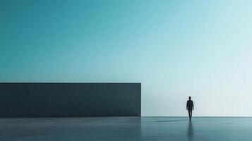 A lone figure walks towards the horizon in a minimalist landscape, evoking feelings of solitude, reflection, and the search for direction. photo