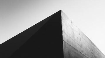 Abstract monochrome image of a concrete structure with strong geometric lines and textures against a bright sky. Minimalist and modern. photo