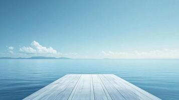 Serene ocean vista with a rustic wooden pier stretching into the horizon, under a clear blue sky with scattered clouds. photo