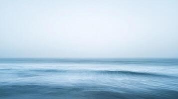 Calming ocean view with soft waves, captured in a serene long exposure, creates a peaceful and minimalist seascape on the horizon. photo