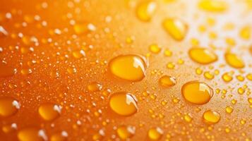 Close-up of water droplets clinging to an orange surface, creating a fresh, glistening effect with varying sizes and shapes. photo