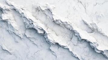 Angled aerial view of a textured white surface featuring jagged edges and subtle shadows, creating a dynamic and abstract topography. photo