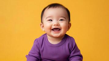 Cheerful baby expressing pure joy and happiness with a bright smile and a warm, inviting gaze against a solid-colored background. photo