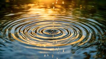 Water drop creates ripples on the surface, reflecting sunlight in mesmerizing patterns, illustrating tranquility and serenity of nature. photo