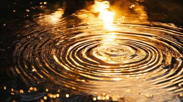 Water ripples with golden light reflections. The concentric circles expand from a central point, creating a mesmerizing effect. photo