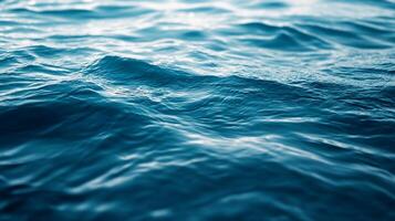 Serene blue water surface reflecting soft light, gentle ripples, and calming aquatic scene. A calming visual of the open sea. photo