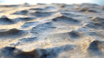Abstract close-up of an undulating landscape. The texture is varied, with light and shadow playing across the small crests and valleys. photo