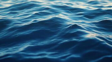 Captivating ocean waves cascade and ripple, sunlight dancing on the surface of the blue sea creating a serene, calming atmosphere. photo
