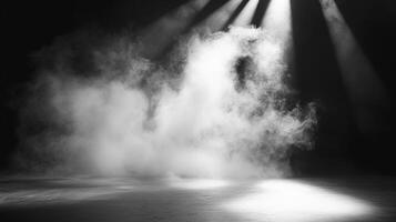 Monochrome scene of a dimly lit empty stage illuminated by shafts of light piercing through ethereal smoke, creating a sense of drama. photo