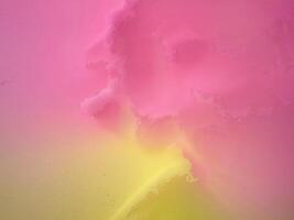 Gradient background blends bright pink and yellow creating a textured surface with a noise effect. photo