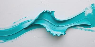A blue wave of paint on a white surface photo