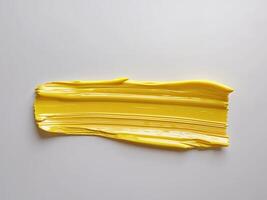 Yellow brushstroke with distinct horizontal lines creates a textured and dynamic background element. photo