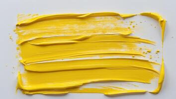 Yellow brushstroke creates a textured rectangular shape with visible brush marks adding a burst of sunshine and energy to any design. photo
