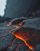 Natural volcanic rock formation with glowing lava cracks in a dark environment. photo