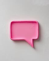 Pink speech bubble plasticine in a textured rectangular shape with a pointed tip photo