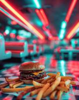 A hamburger and french fries sit on a checkered table photo
