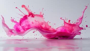 Watercolor shape with splattered pink hues creates a dynamic and expressive design element. photo